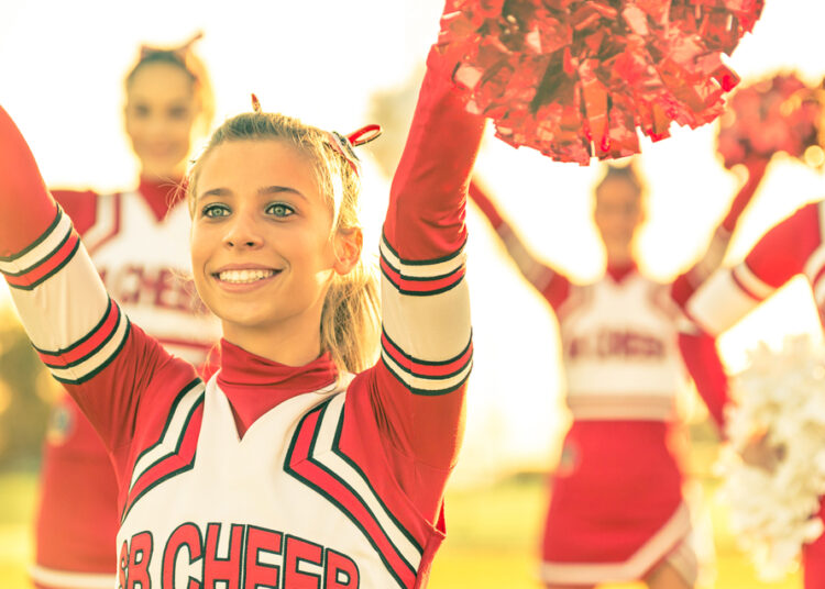 High school football team show incredible compassion to cancer-stricken cheerleader.